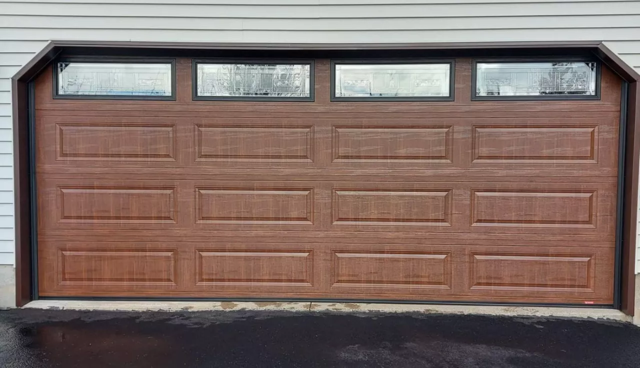 A brown garage door with windows, combining practicality and design in a cohesive look.